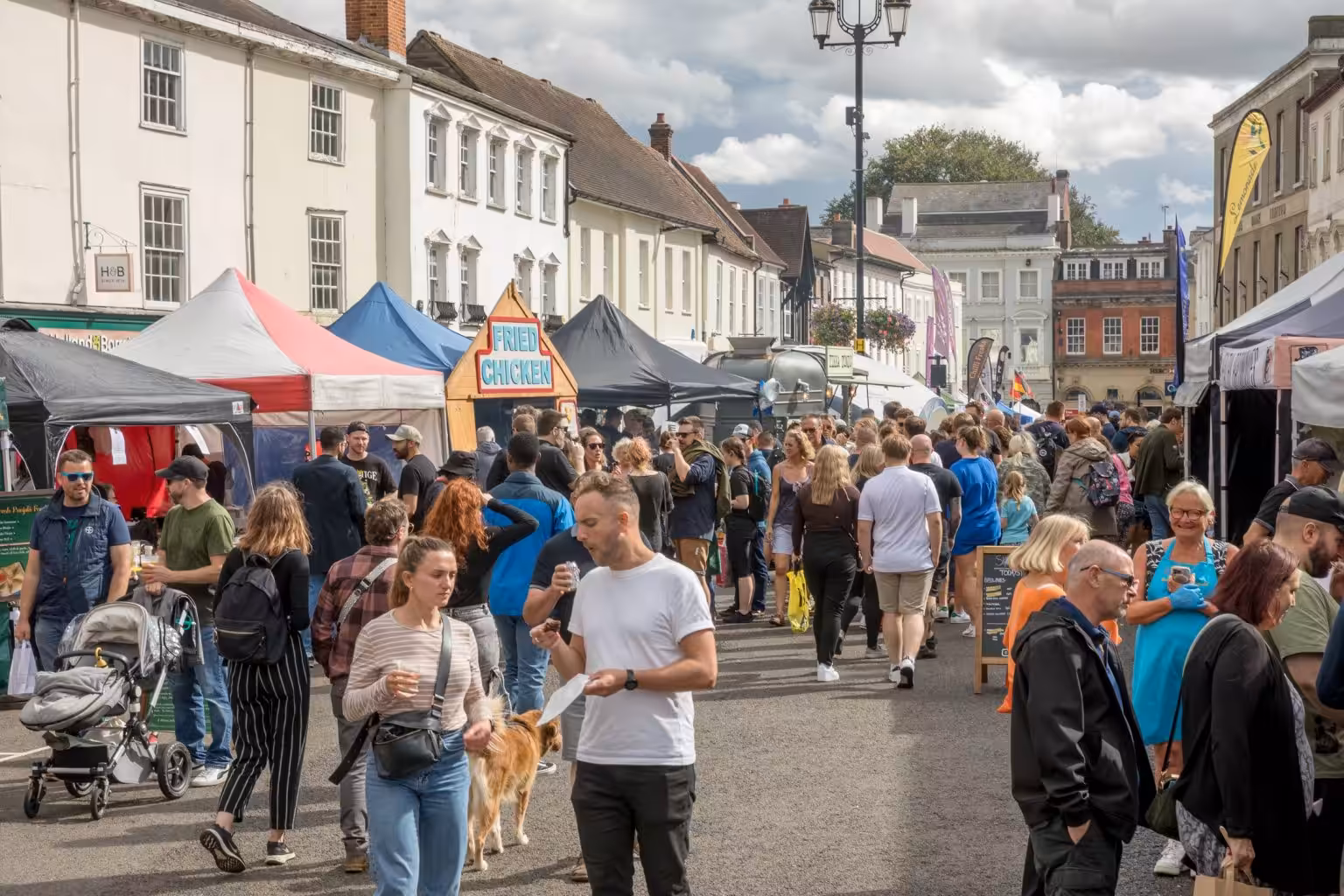 Crowds enjoying the Bury St Edmunds Food & Drink Festival, with bustling market stalls and a lively atmosphere. – WinuSoft | Bury St Edmunds Web Design Company